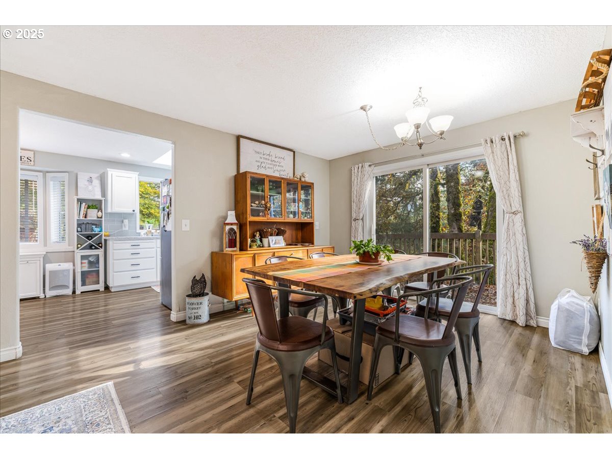 56220 Southwest Lee Falls Road Gaston, OR 97119 - Photo 15 of 44 a view of a dining room with furniture and wooden floor
