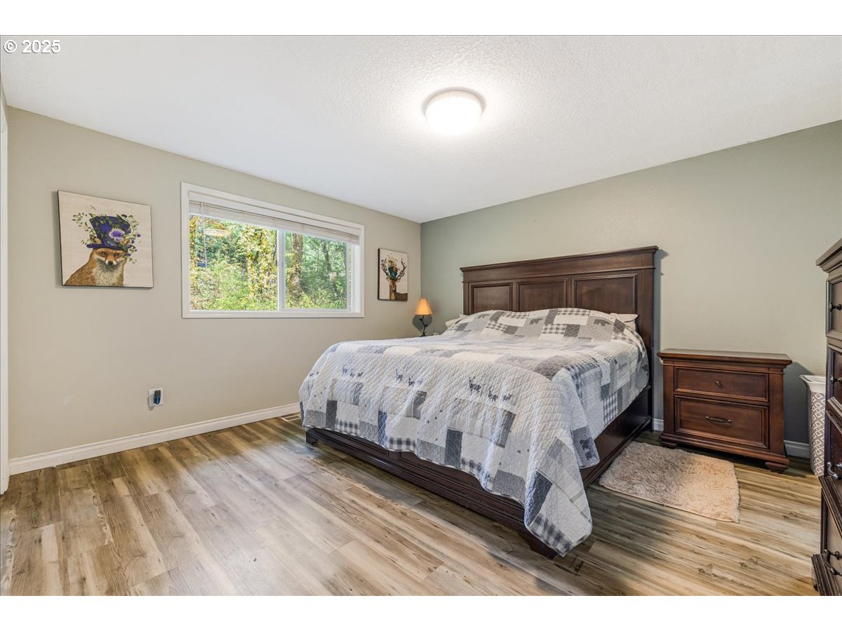 56220 Southwest Lee Falls Road Gaston, OR 97119 - Photo 19 of 44 a bed sitting in a bedroom next to a window