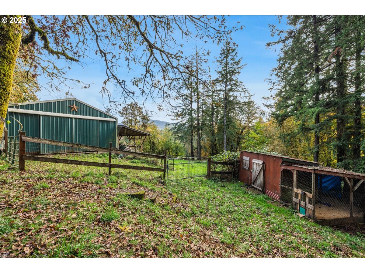 56220 Southwest Lee Falls Road Gaston, OR 97119 - Photo 32 of 44 a view of backyard with wooden fence and a bench