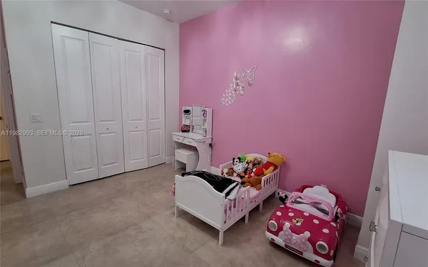 a bedroom with two beds and a chandelier