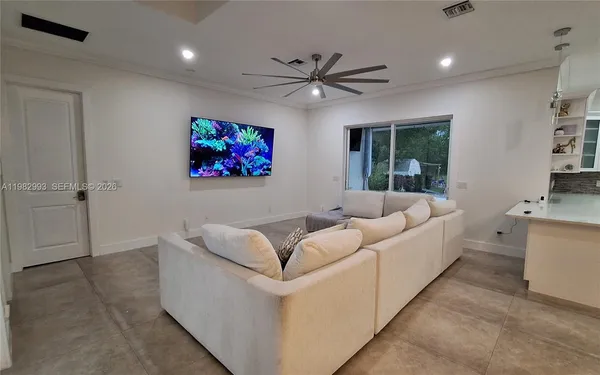 a large living room with stainless steel appliances furniture a rug and a view