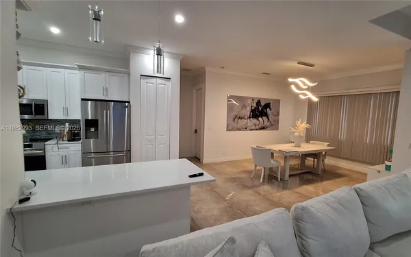 a kitchen with stainless steel appliances granite countertop a refrigerator and a sink