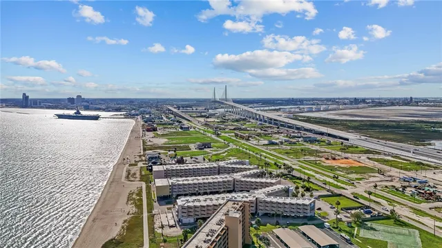 a view of a swimming pool with lawn chairs and a barbeque