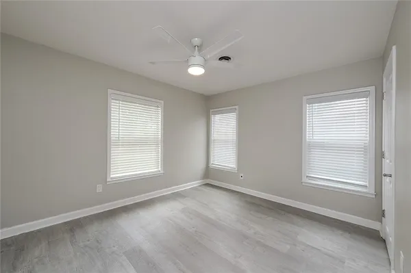 an empty room with windows and closet