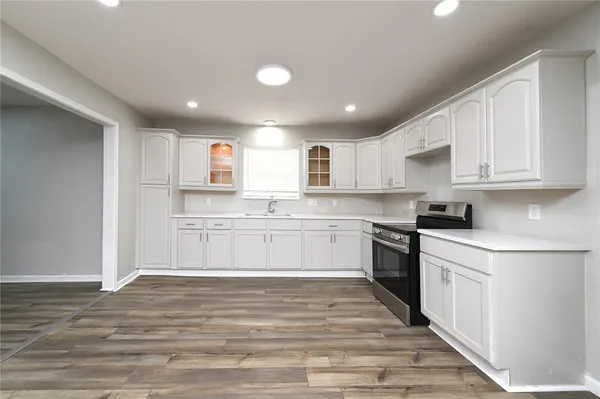 a kitchen with granite countertop white cabinets and white appliances
