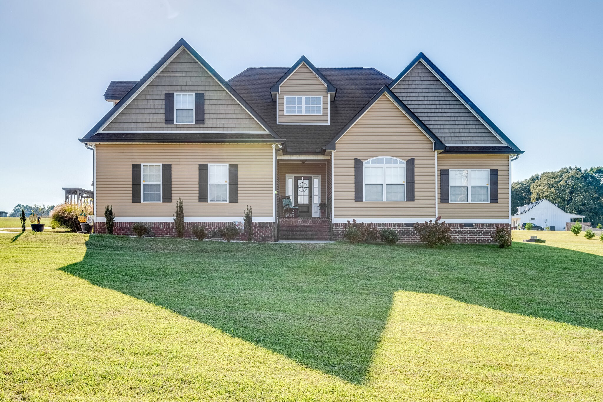 932 Goslin Branch Road Burns, TN 37029 - Photo 1 of 24 a front view of a house with a yard and trees