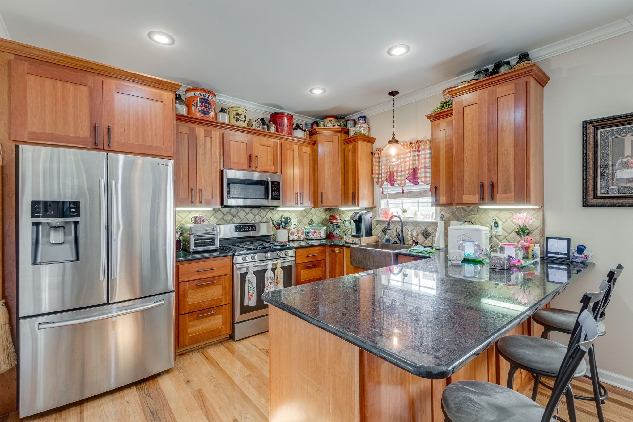 932 Goslin Branch Road Burns, TN 37029 - Photo 11 of 24 a kitchen with stainless steel appliances granite countertop a refrigerator a stove top oven a sink dishwasher and wooden cabinets