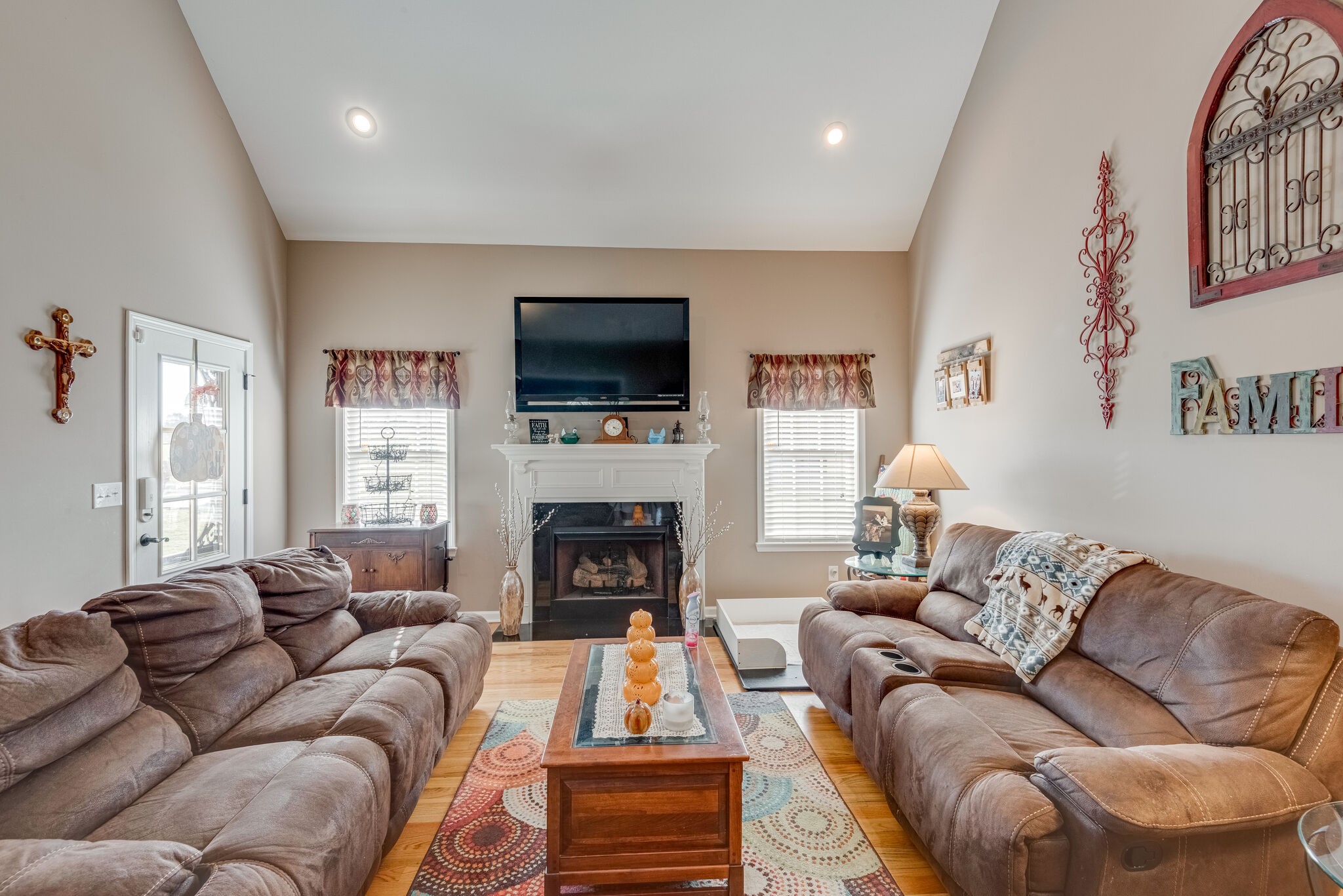 932 Goslin Branch Road Burns, TN 37029 - Photo 7 of 24 a living room with furniture a fireplace and a flat screen tv