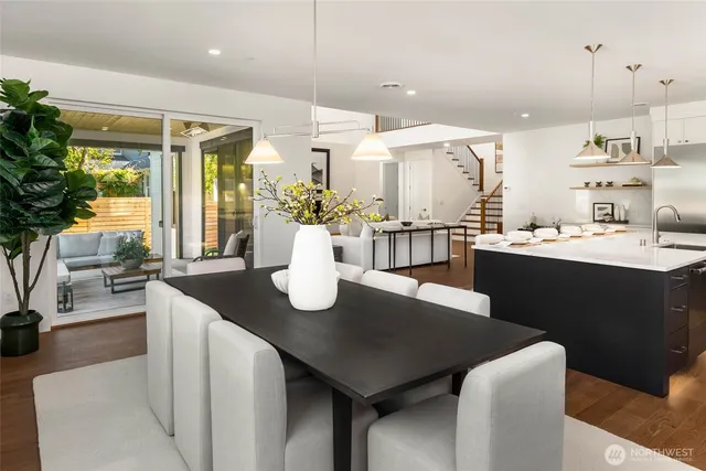 a dining room with kitchen island a table and chairs in it