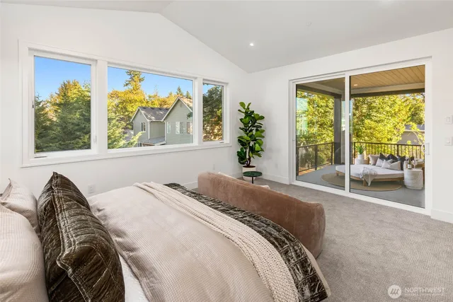 a spacious bedroom with a bed and a large window