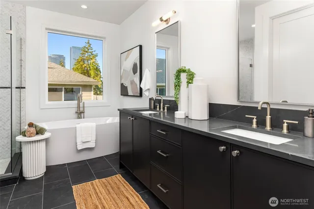 a bathroom with a double vanity sink a toilet and a mirror