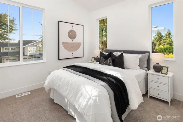 a bedroom with a bed and a painting on the wall