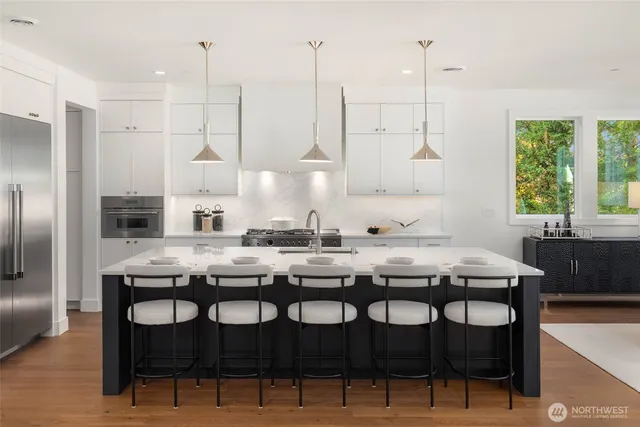 a kitchen with granite countertop a table chairs stove and kitchen island