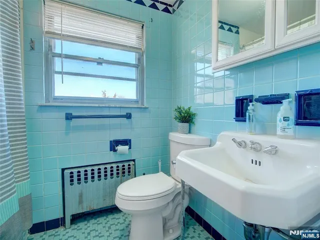 a white toilet sitting next to a bathroom sink