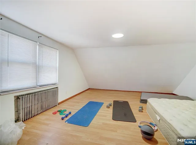 a view of a room with wooden floor and windows
