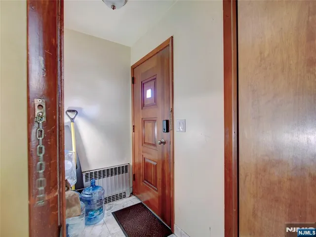 a view of a hallway with a door and stairs