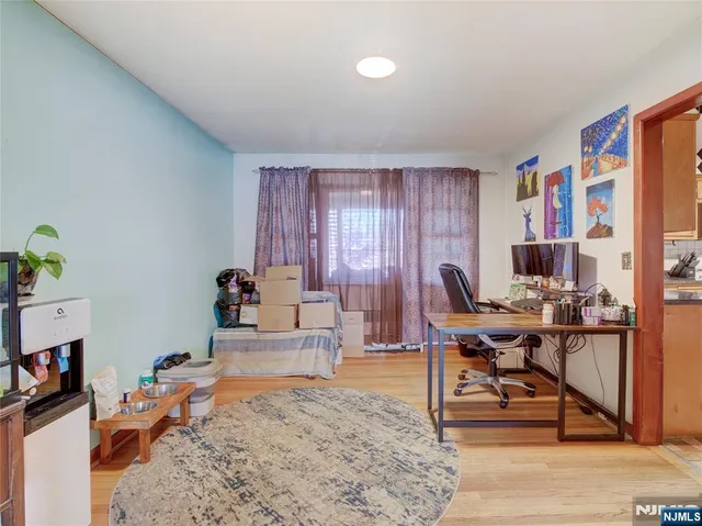 a living room with furniture a rug and a flat screen tv