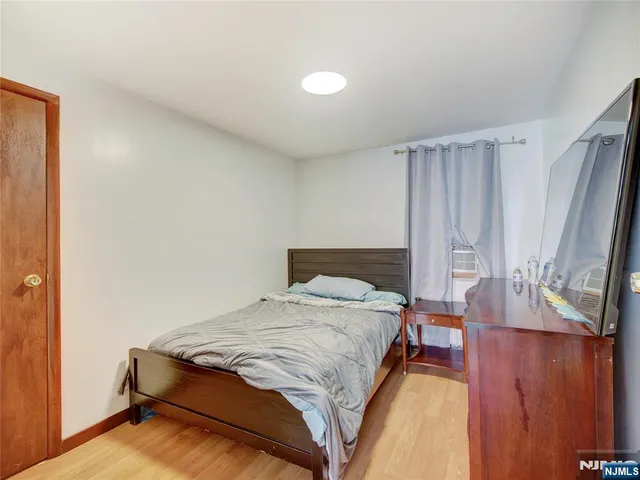 a bedroom with a bed and a mirror