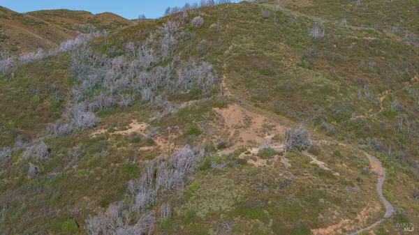 a view of a mountain range in a cloudy sky