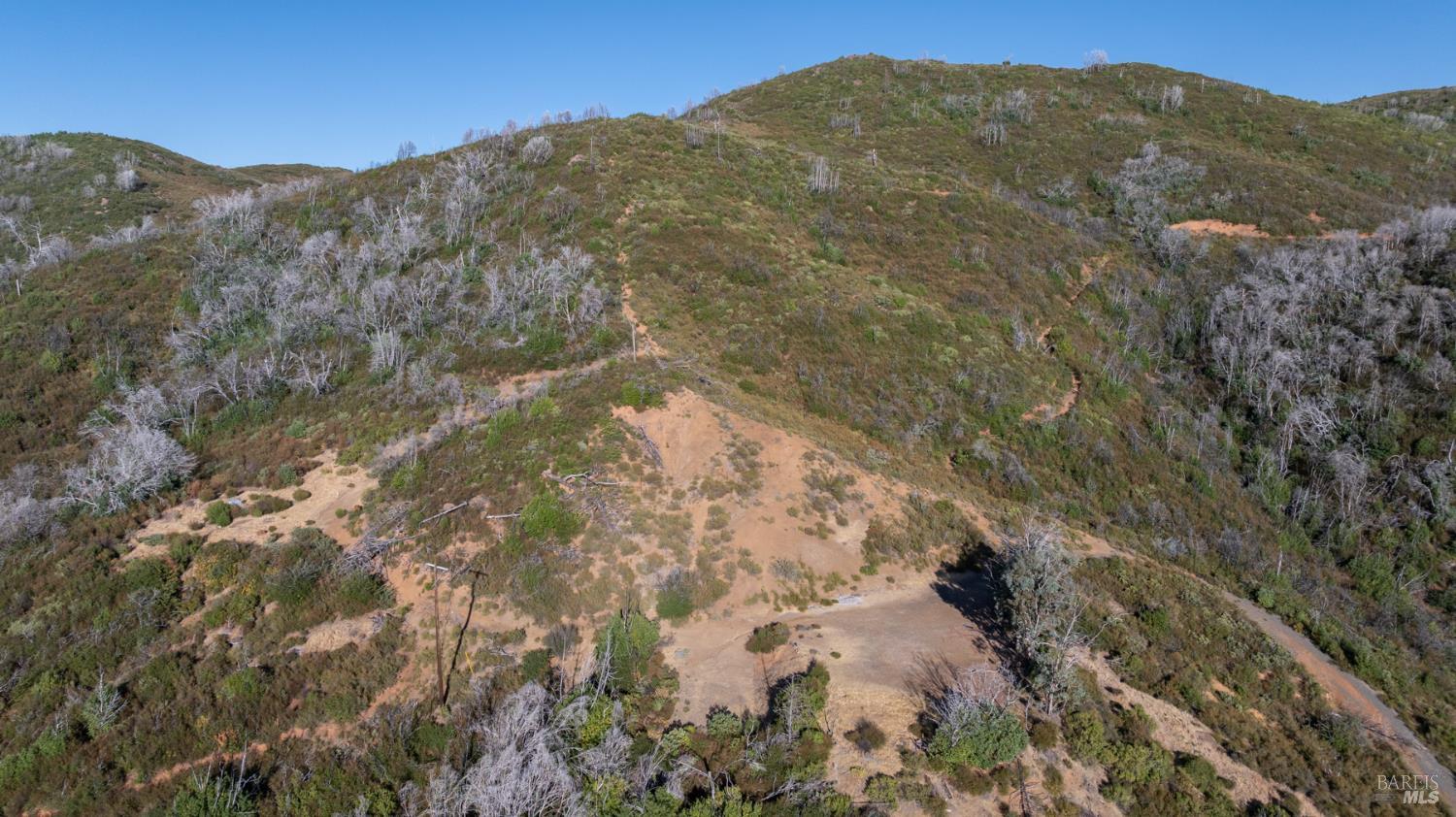 7051 Geysers Road Geyserville, CA 95441 - Photo 13 of 21 a view of a dry yard with mountains in the background