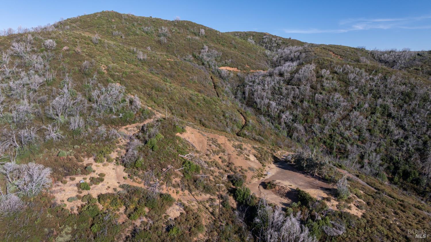 7051 Geysers Road Geyserville, CA 95441 - Photo 14 of 21 a view of a mountain range in a cloudy sky