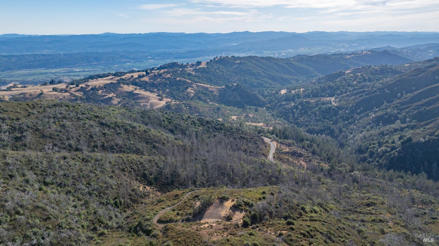 7051 Geysers Road Geyserville, CA 95441 - Photo 18 of 21 a view of a dry field with mountains in the background