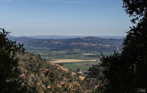 a view of a town with mountains in the background