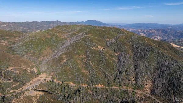 a view of a mountain with a mountain in the background