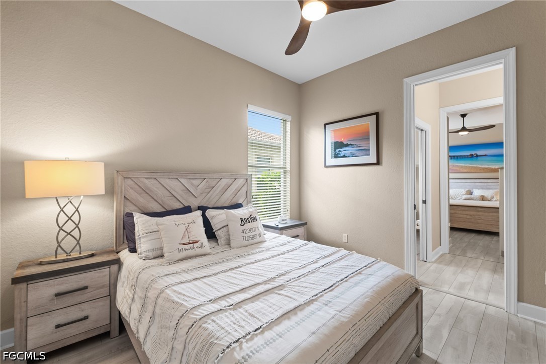 9042 Bronco Court Naples, FL 34113 - Photo 25 of 50 a bedroom with a large bed and a lamp