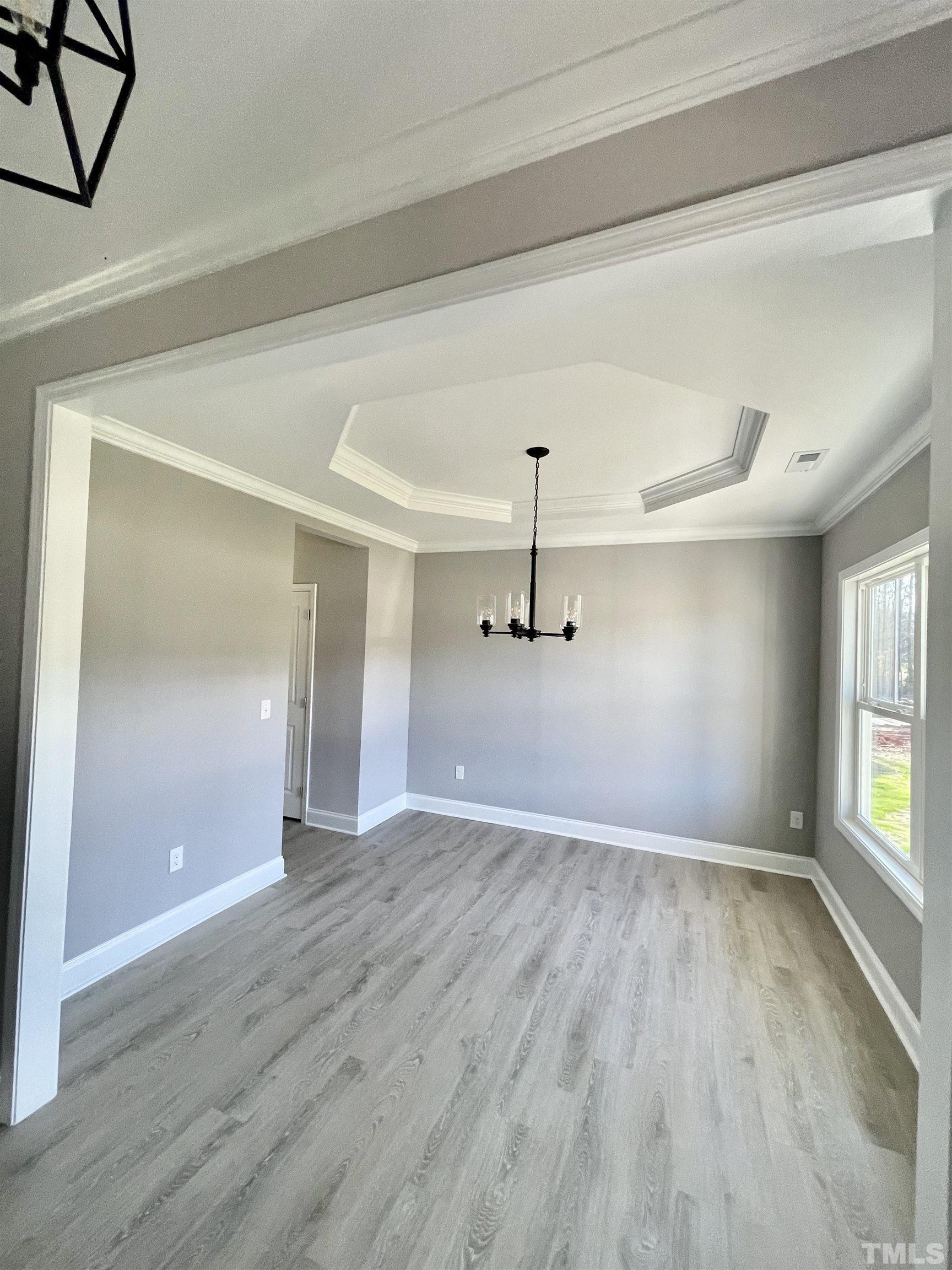 10667 West Old Spring Hope Road Spring Hope, NC 27882 - Photo 5 of 9 wooden floor in an empty room with a window