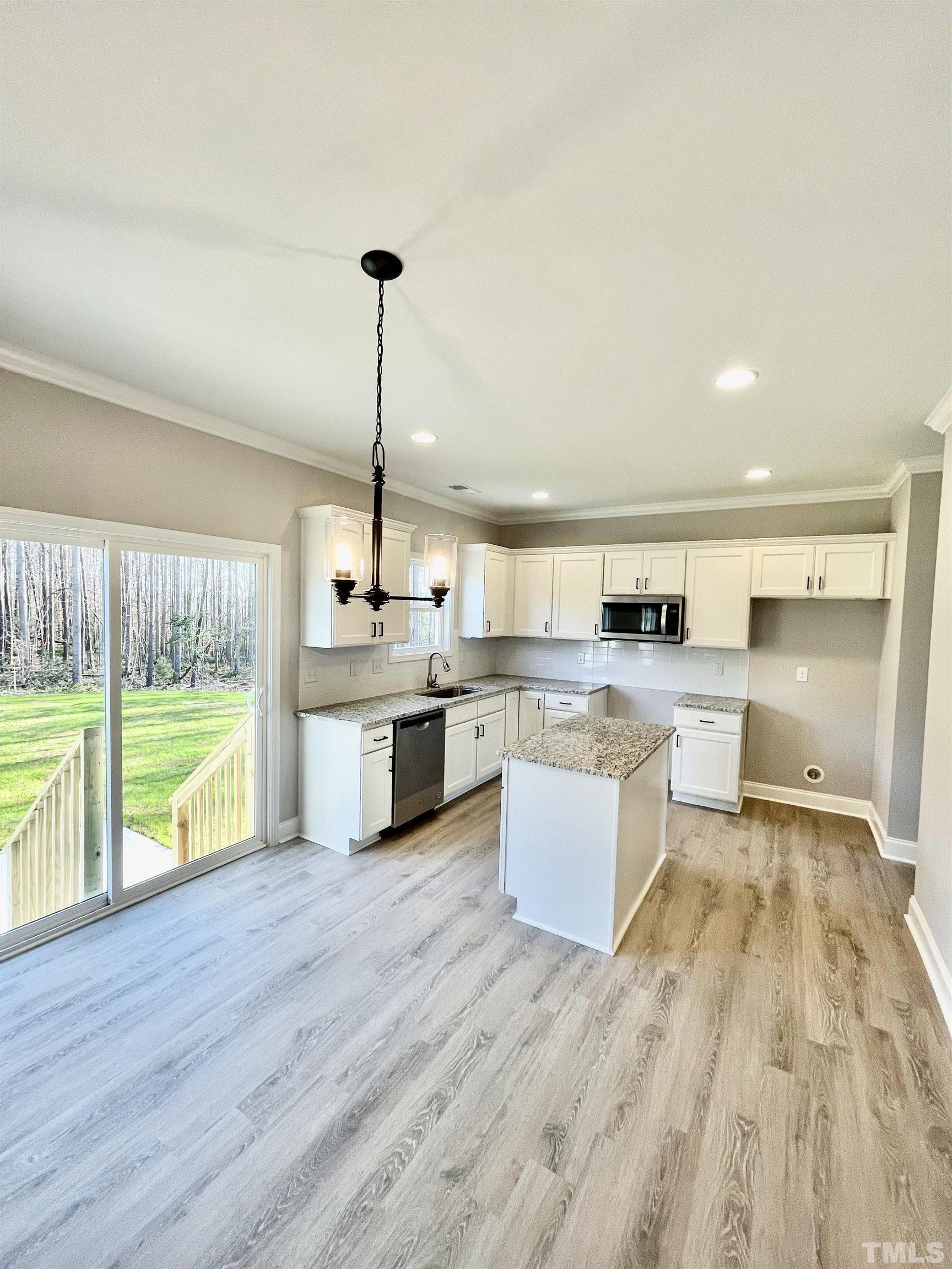 10667 West Old Spring Hope Road Spring Hope, NC 27882 - Photo 8 of 9 a large white kitchen with a large window and stainless steel appliances