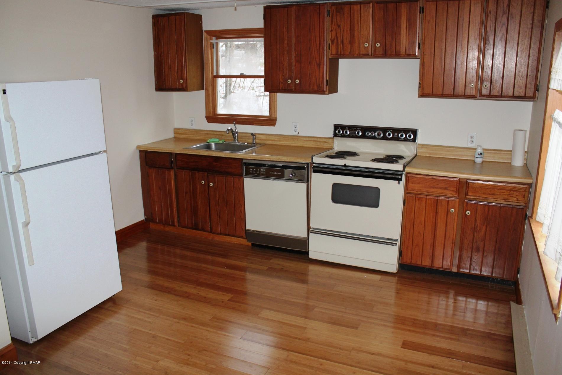 1055 Bush Road Cresco, PA 18326 - Photo 8 of 24 a kitchen with a stove a refrigerator and a sink