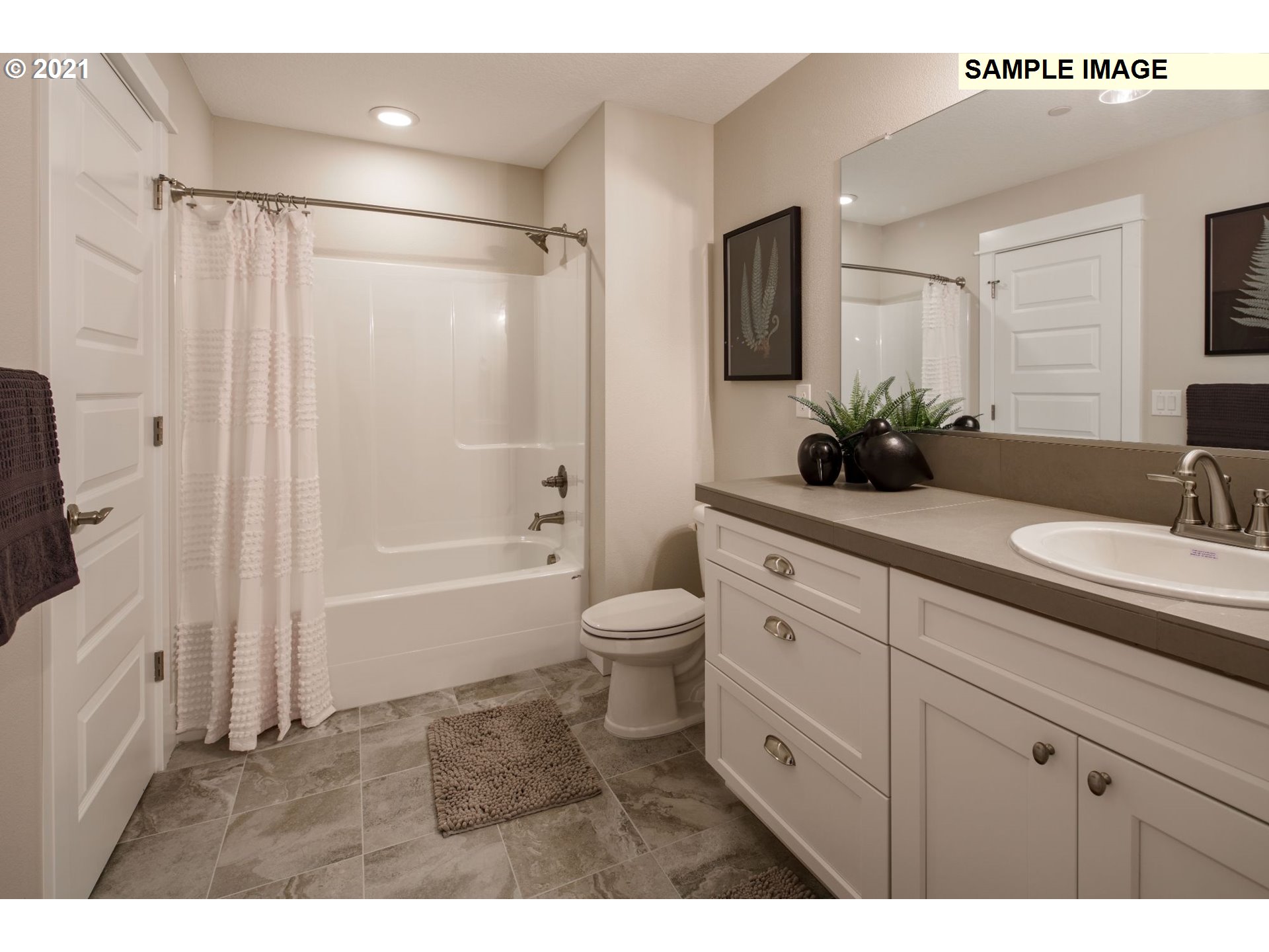 South Cherry Grove Way Ridgefield, WA 98642 - Photo 21 of 32 a bathroom with a granite countertop sink toilet a large mirror a shower and a bathtub