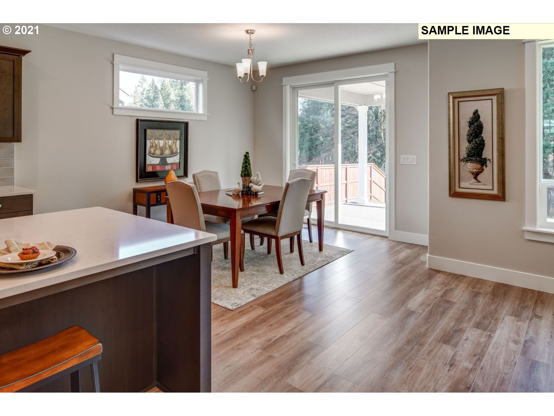 South Cherry Grove Way Ridgefield, WA 98642 - Photo 9 of 32 a view of a dining room with furniture a chandelier and wooden floor