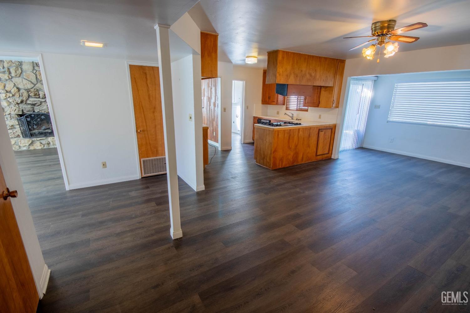 Undisclosed Address Bakersfield, CA 93309 - Photo 11 of 39 a view of a livingroom with wooden floor and a ceiling fan