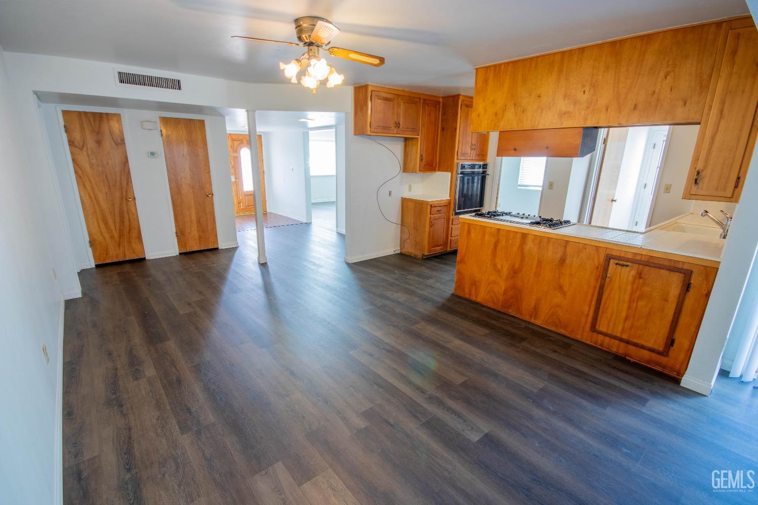 Undisclosed Address Bakersfield, CA 93309 - Photo 13 of 39 a view of an empty room with wooden floor and a window