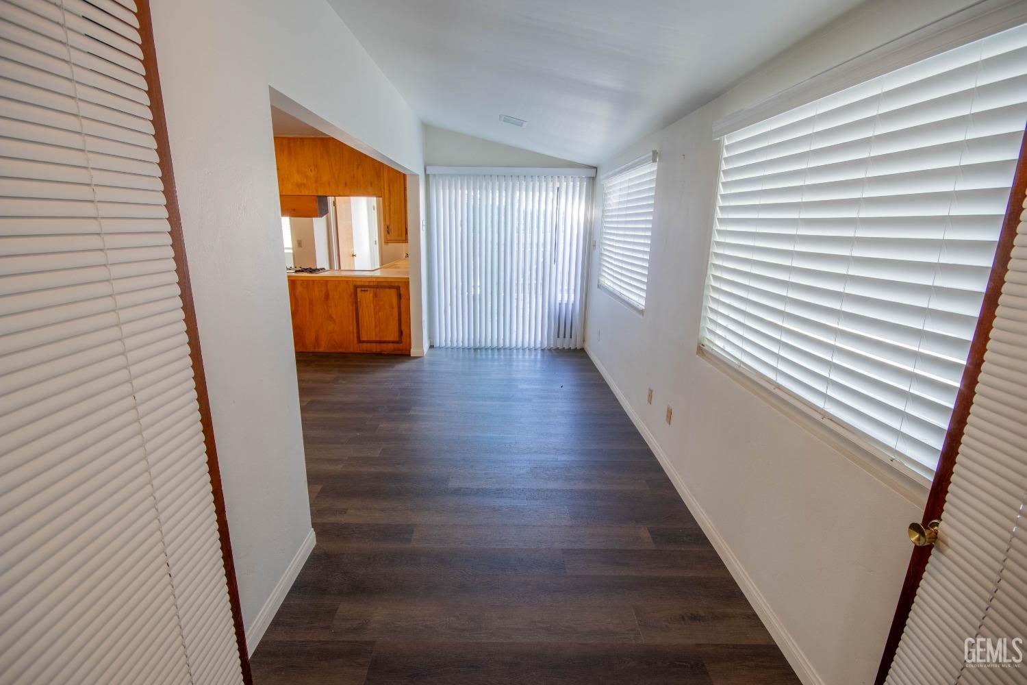 Undisclosed Address Bakersfield, CA 93309 - Photo 17 of 39 a view of a hallway with wooden floor and staircase