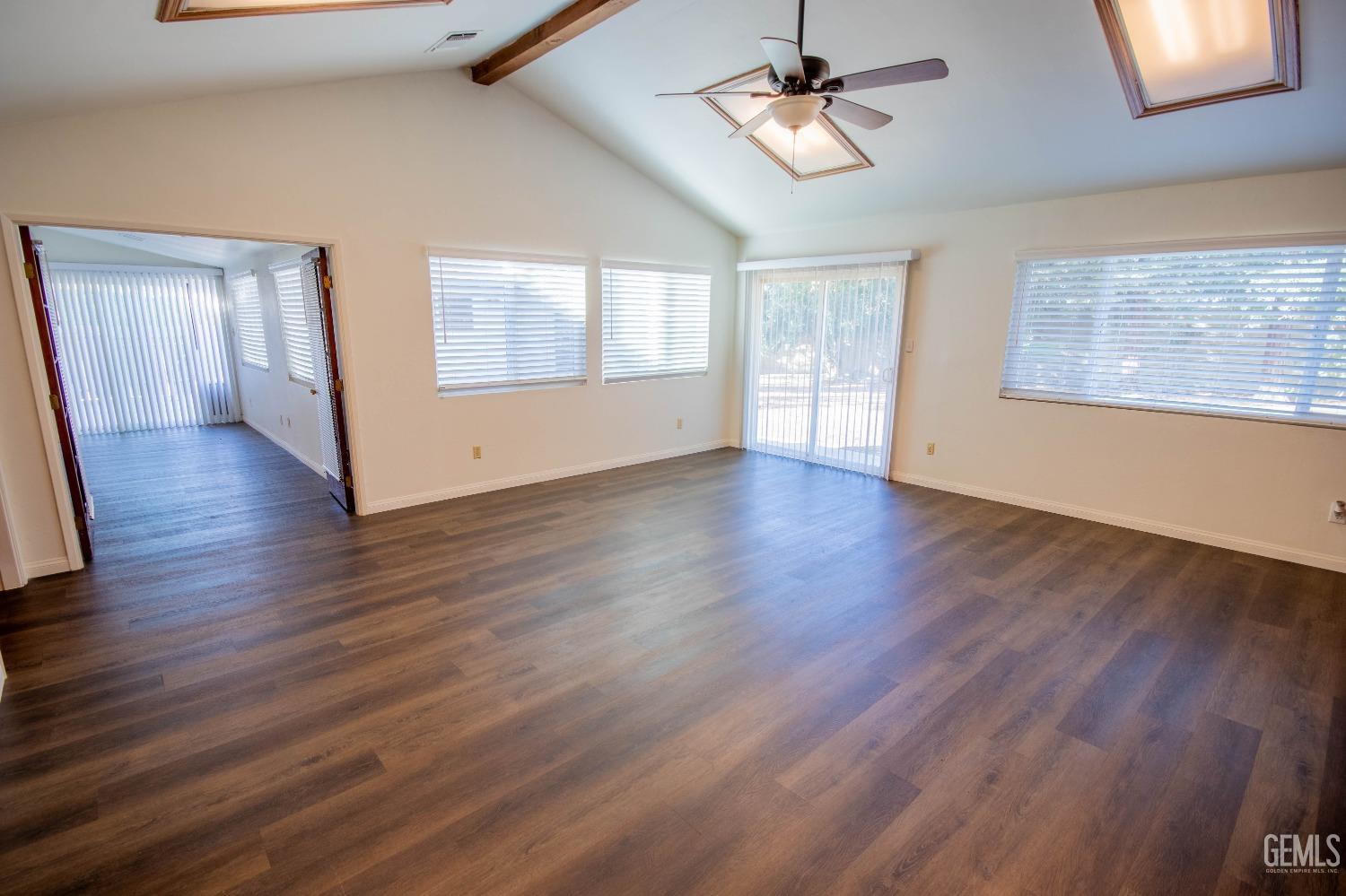 Undisclosed Address Bakersfield, CA 93309 - Photo 19 of 39 a view of an empty room with wooden floor and a window