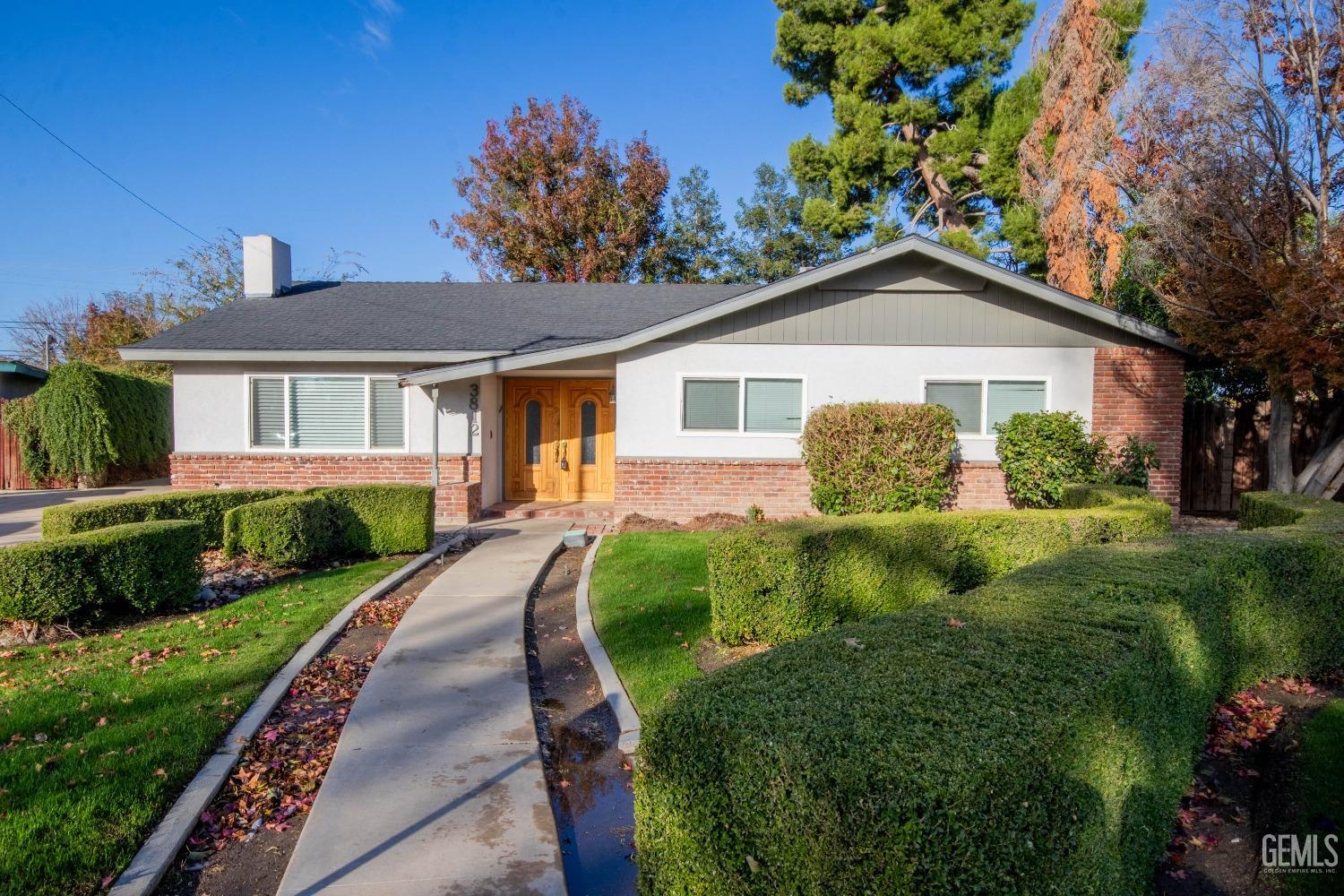 Undisclosed Address Bakersfield, CA 93309 - Photo 2 of 39 a front view of a house with garden