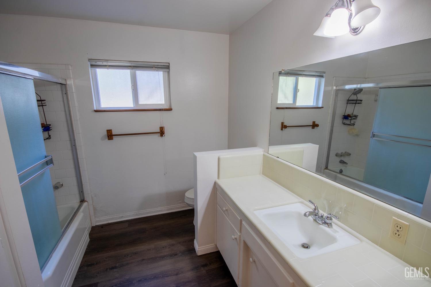 Undisclosed Address Bakersfield, CA 93309 - Photo 26 of 39 a bathroom with a sink a mirror and a bathtub