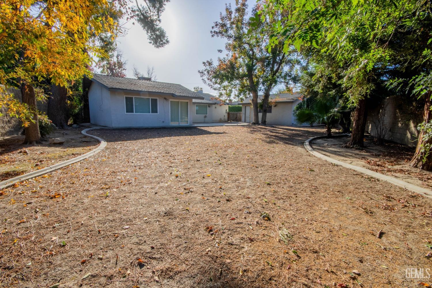 Undisclosed Address Bakersfield, CA 93309 - Photo 33 of 39 a front view of a house with a yard and garage