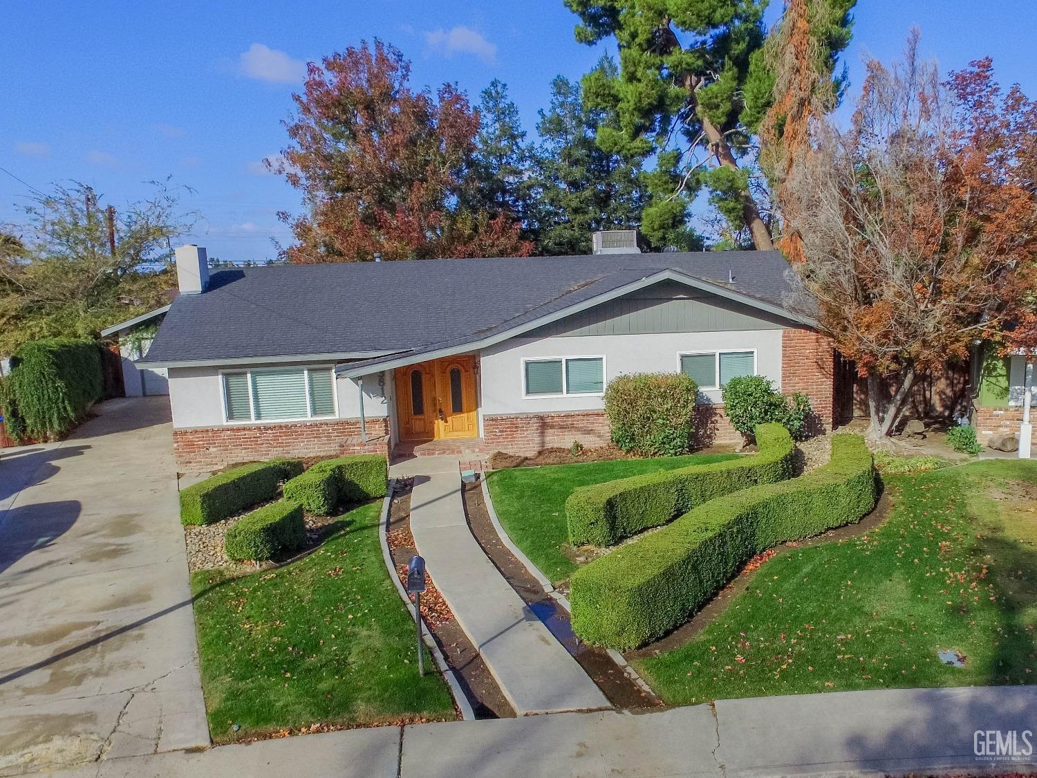 Undisclosed Address Bakersfield, CA 93309 - Photo 4 of 39 a front view of a house with a yard