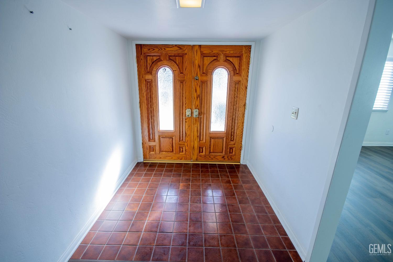 Undisclosed Address Bakersfield, CA 93309 - Photo 6 of 39 an empty room with wooden floor and mirror