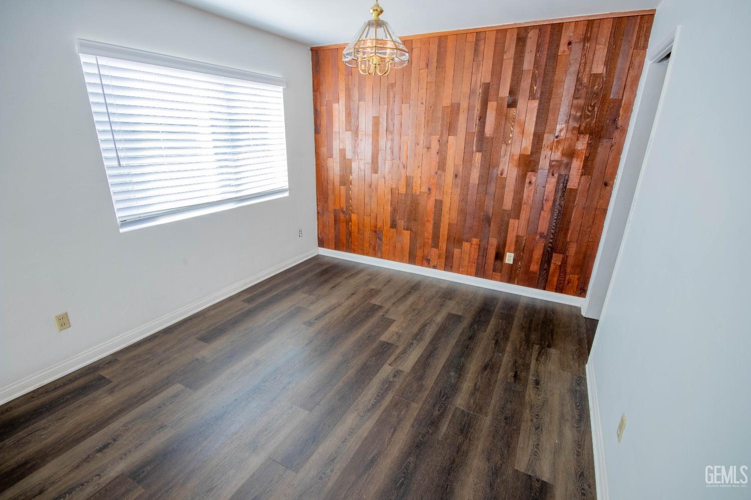 Undisclosed Address Bakersfield, CA 93309 - Photo 9 of 39 a view of a room with wooden floor and a window