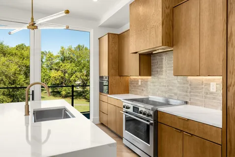a view of open kitchen with granite countertop cabinets and outdoor view