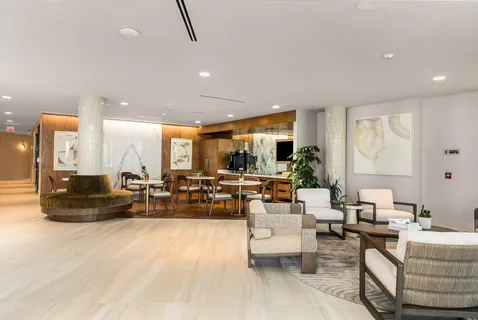 a view of a balcony with chairs and a table under an umbrella