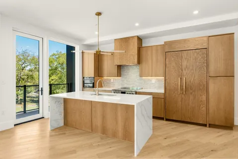 a large white kitchen with a large window