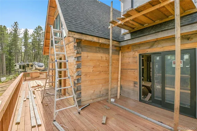 a view of a balcony with door and wooden floor