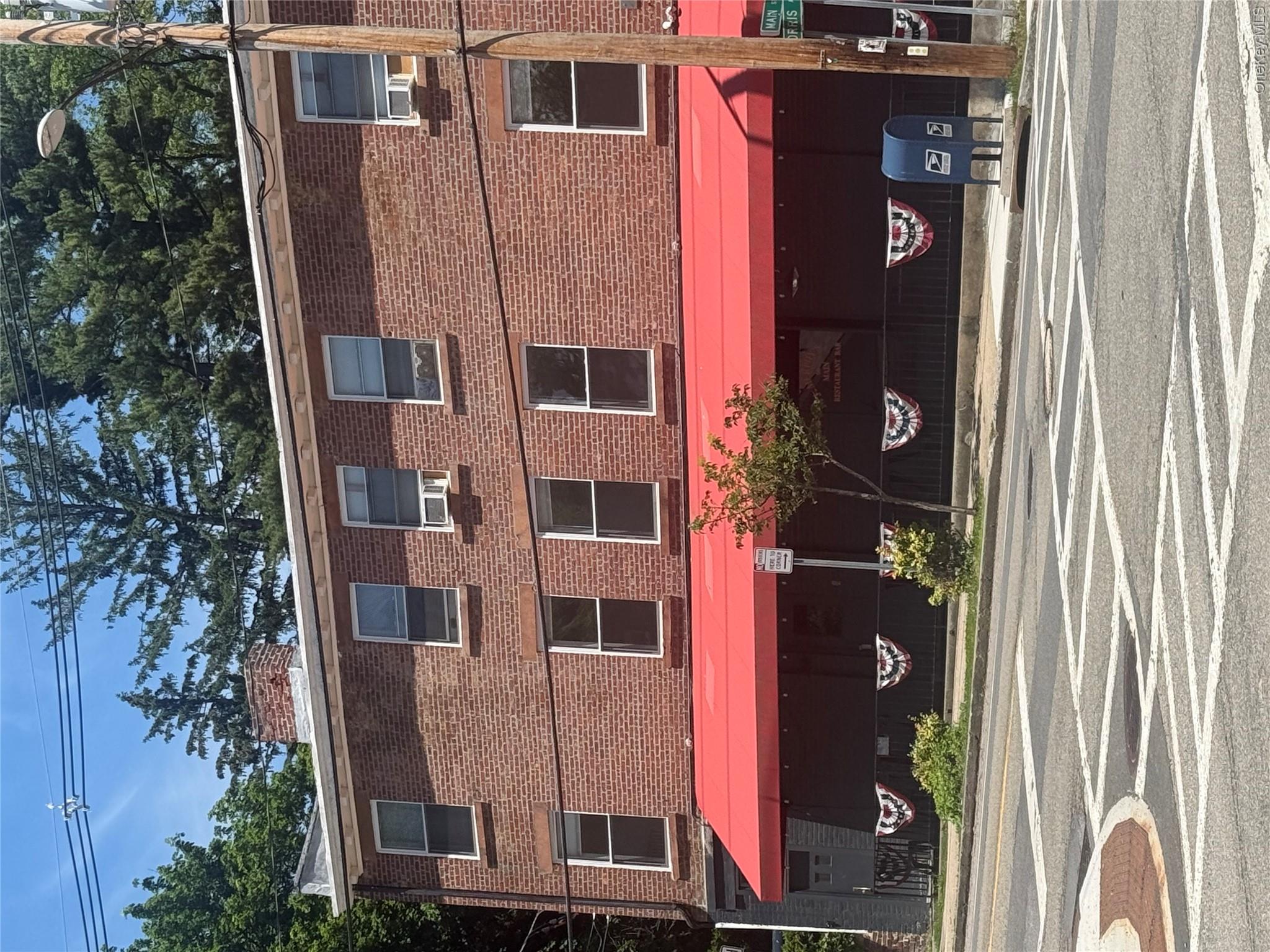 a view of building with car parked