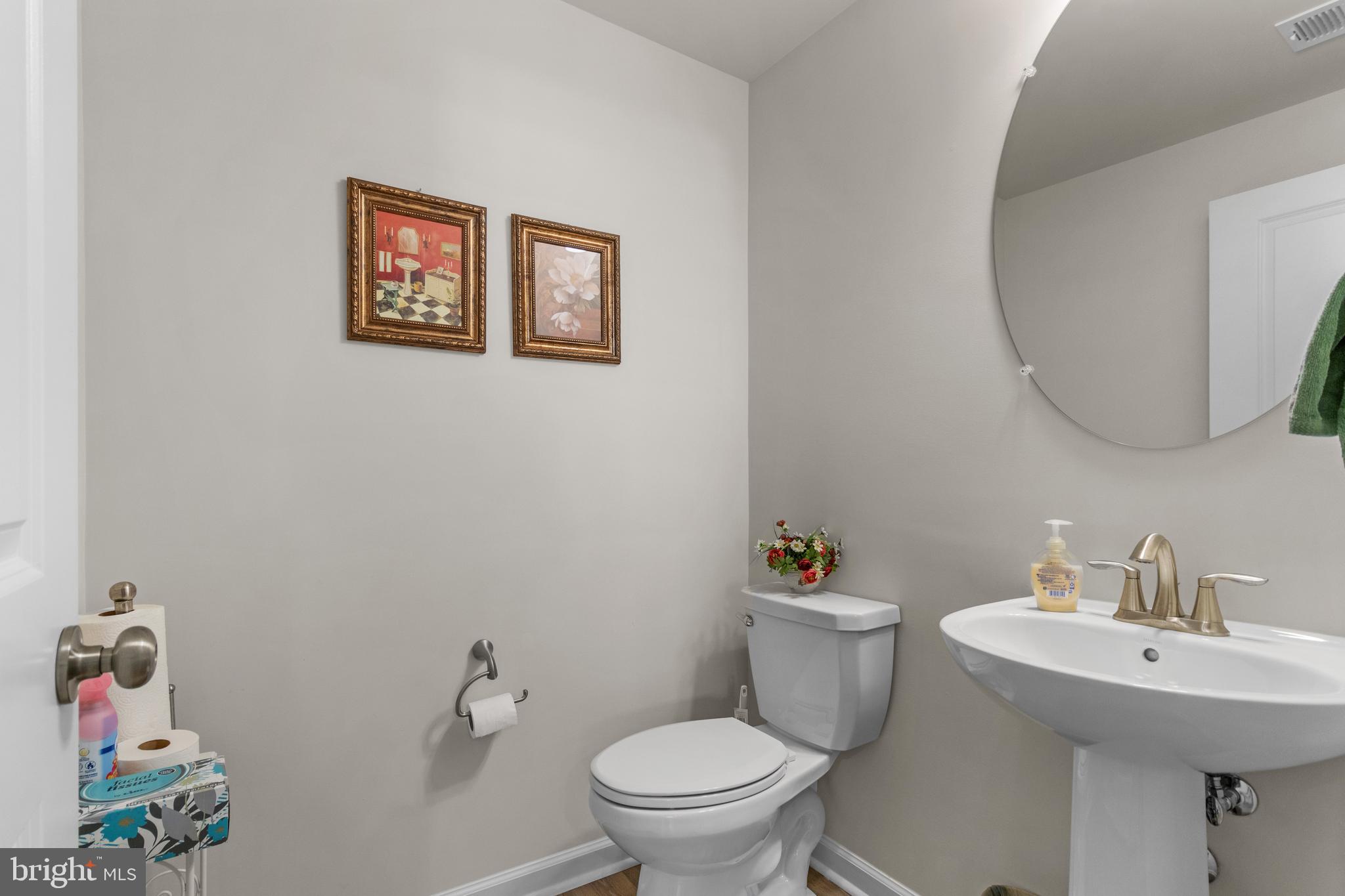 12129 American Chestnut Road Bowie, MD 20720 - Photo 11 of 25 a bathroom with a toilet a sink and a mirror